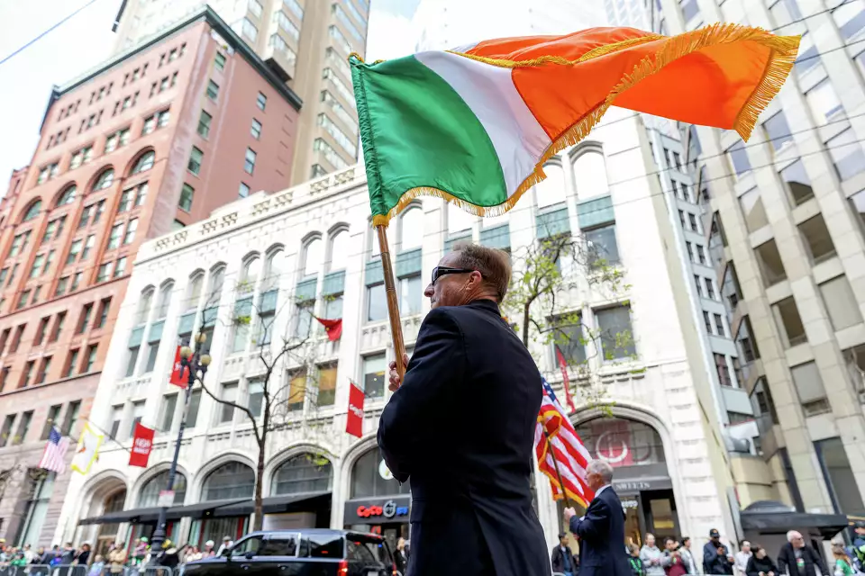 A participant waves an Irish flag during the 174th annual St. Patrick’s Day Parade in San Francisco.